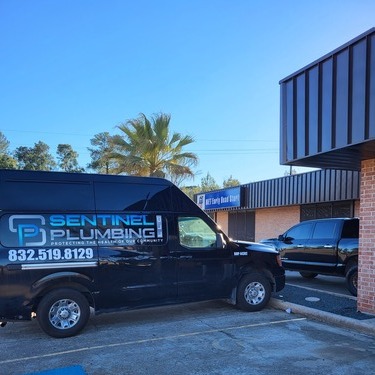 plumbing van in front of a building